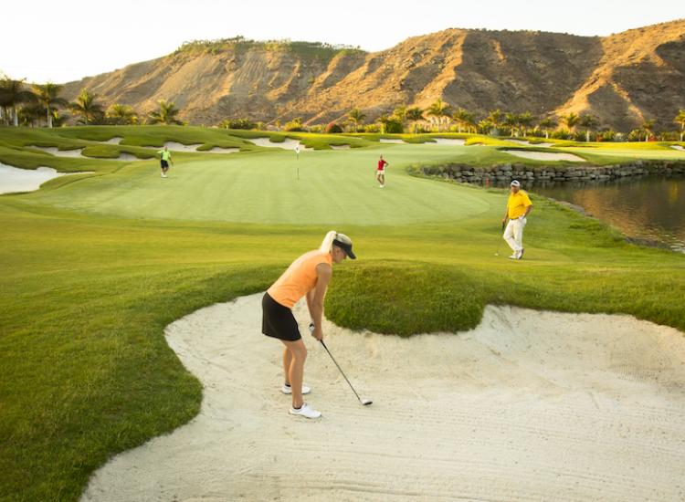 lady golfer in sand trap